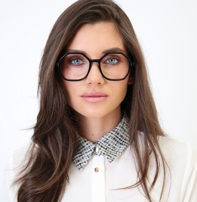 Brunette model with a collared blouse wearing Magdalena Optical Black Optical