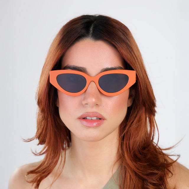 Model with red hair wearing Mary Lou Sunglasses Aperol with Grey Flat