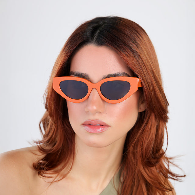 Another angle of model with red hair wearing Mary Lou Sunglasses Aperol with Grey Flat