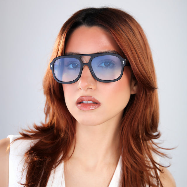 Another angle of woman with red hair Memphis Sunglasses front view in Black with Blue Gradient See Through