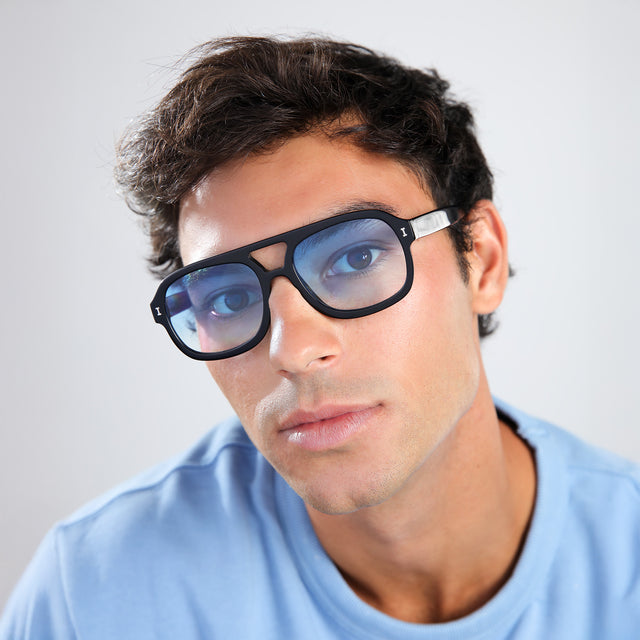Man in a blue shirt wearing Memphis Sunglasses Black with Blue Gradient See Through