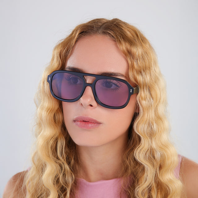 Another angle of woman with blonde, wavy hair wearing Memphis Sunglasses Black with Plum See Through