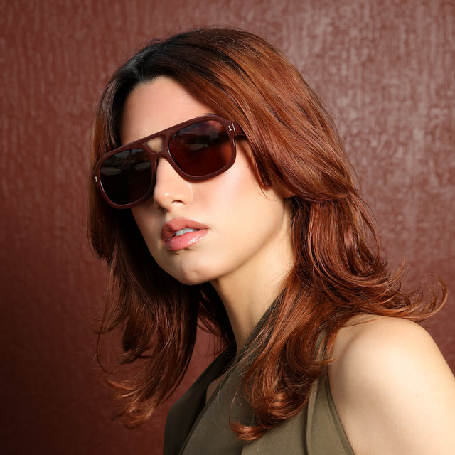 Another angle of woman with red hair in an olive blouse wearing Memphis Sunglasses Bordeaux with Brown
