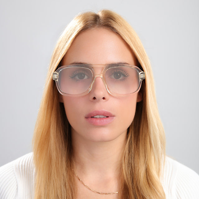Blonde woman in a textured white cardigan wearing Memphis Sunglasses Champagne with Taupe Gradient