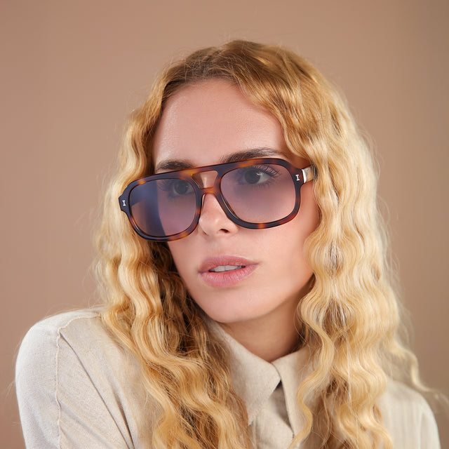 Woman with blonde, wavy hair wearing Memphis Sunglasses Havana with Taupe Gradient