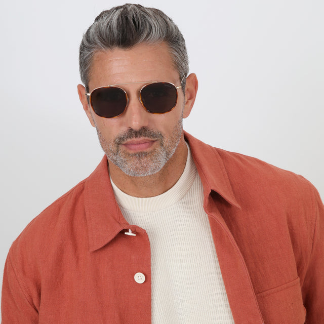 Model with salt and pepper hair and beard wearing Mykonos Ace Sunglasses Havana/Gold with Grey Flat