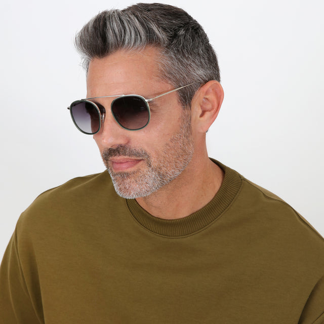 Model with salt and pepper hair and beard wearing Mykonos Ace Sunglasses Pine/Silver with Grey Flat Gradient