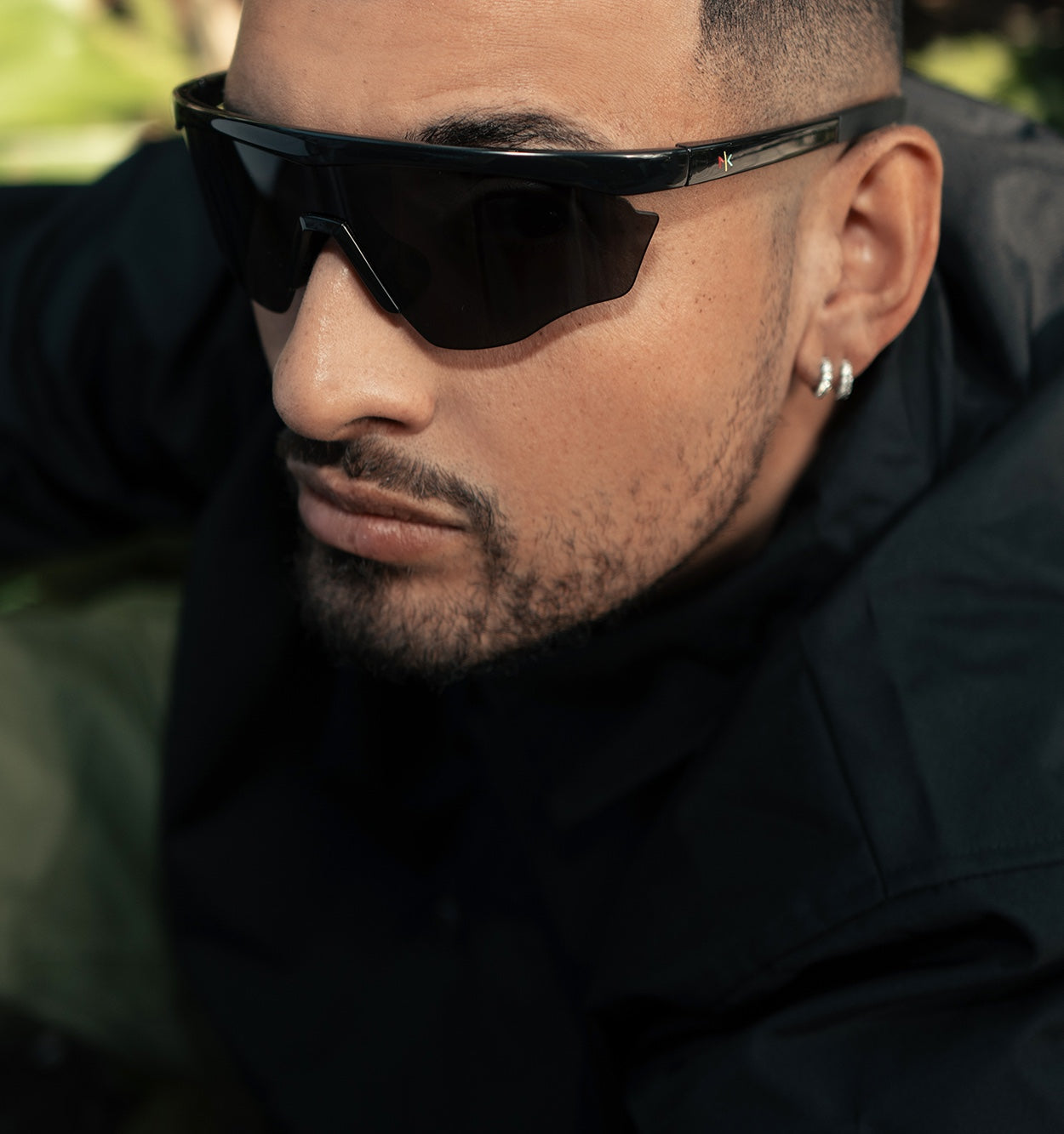 Close up of Nick Kyrgios outdoors wearing Nick Kyrgios x illesteva Sports Frames in Black