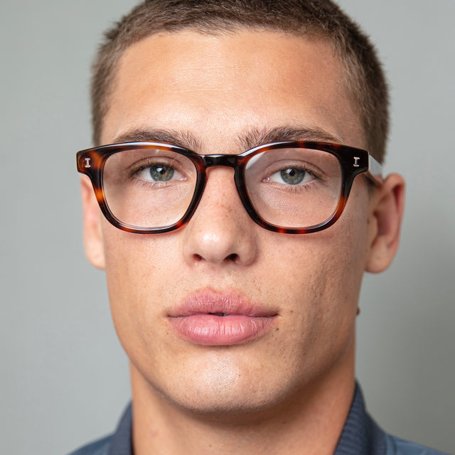 Model with buzzcut hairstyle wearing Pacific Optical Havana Optical