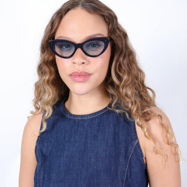 Brunette model with ombré, natural curls wearing Pamela Sunglasses Navy with Ocean Flat Gradient See Through