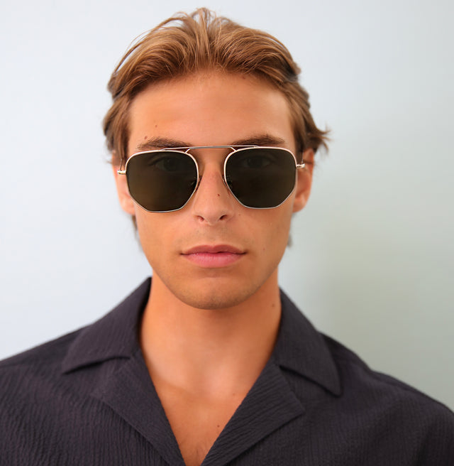 Man with light brown wavy hair wearing Patmos Sunglasses Silver with Olive Flat