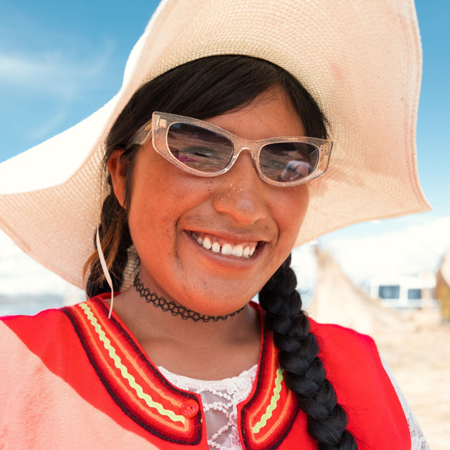 Young Peruvian woman in a sun hat wearing Alexa Sunglasses in Silver Blitz