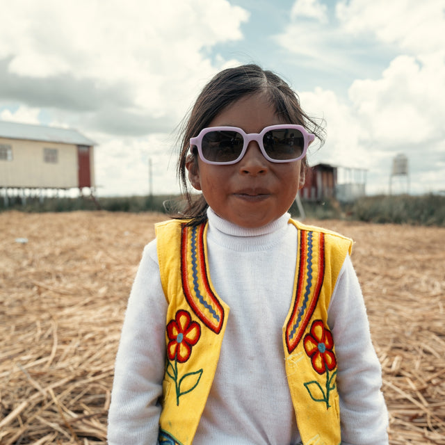 Young Peruvian girl in a field wearing Berlin Sunglasses in Matte Lilac