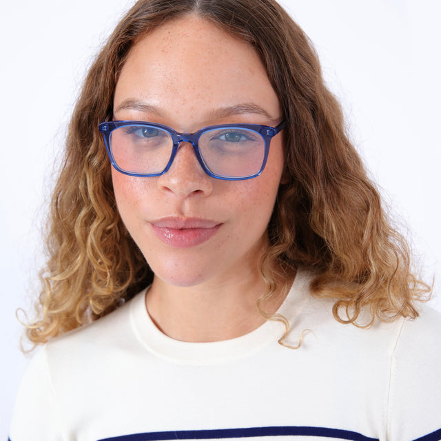 Model with curly, ombre hair wearing Portland Optical Cerulean Optical