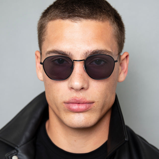 Model with buzzcut hairstyle wearing Prince Sunglasses Black with Grey Flat