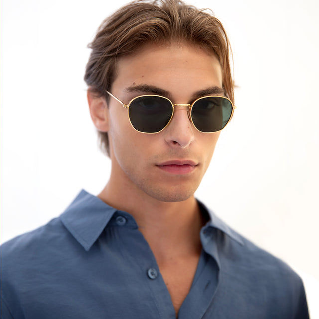 Model with short, light brown hair wearing Prince Sunglasses Gold with Olive Flat