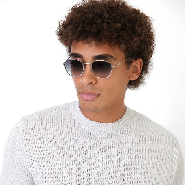 Model with natural curls wearing Prince Sunglasses Gunmetal with Grey Flat Gradient