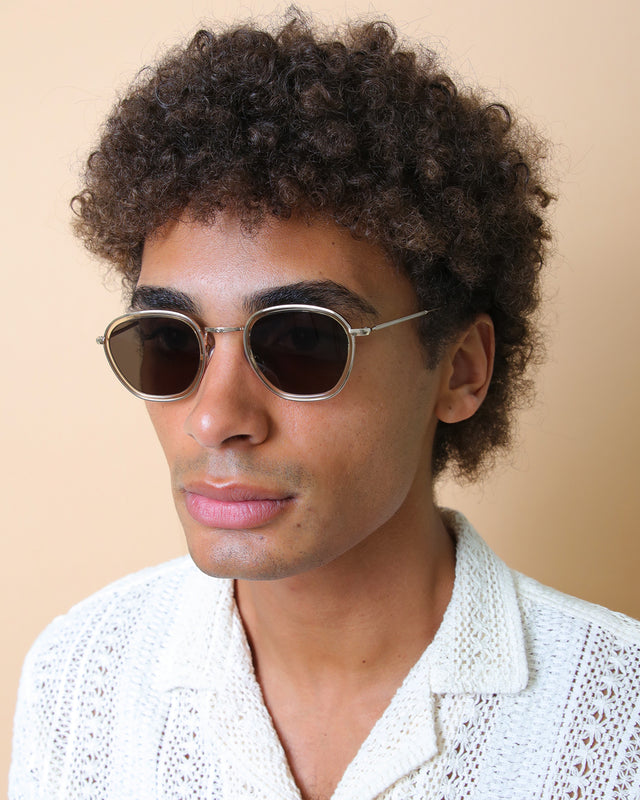 Model with afro-curly hair wearing Prince Tate Sunglasses Citrine/Gold with Grey Flat