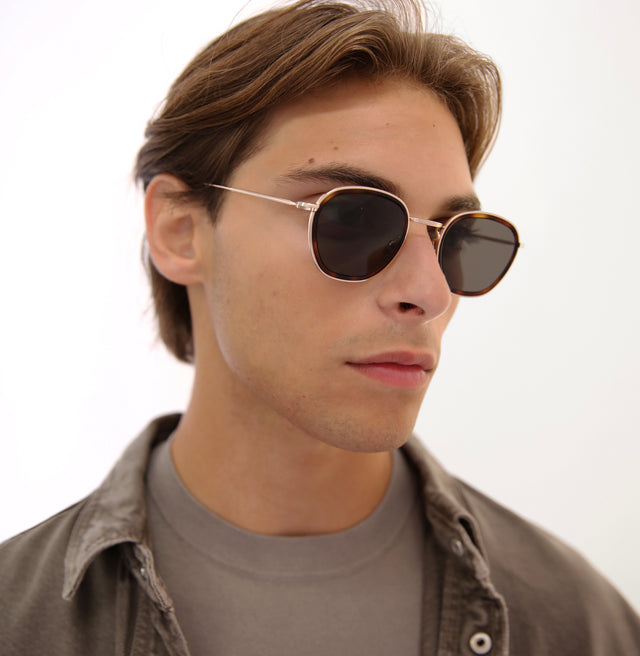 Model with short, brown hair combed back wearing Prince Tate Sunglasses Havana/Gold with Grey Flat