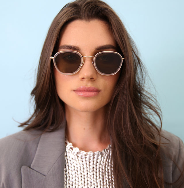 Brunette model with wavy hair wearing Prince Tate Sunglasses Matte Clear/Gold with Brown Flat
