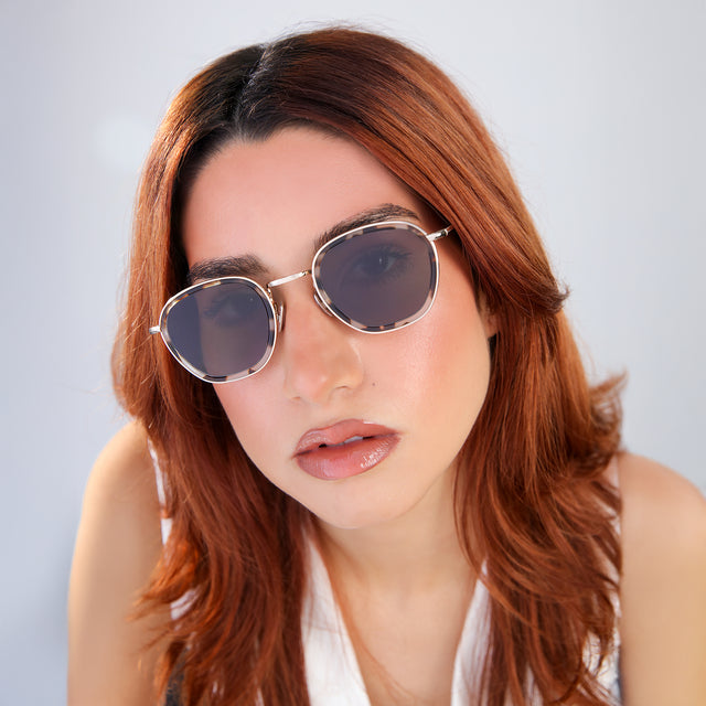 Close up of woman with red hair in a white blouse Prince Tate Sunglasses side view in White Tortoise/Gold / Grey Flat
