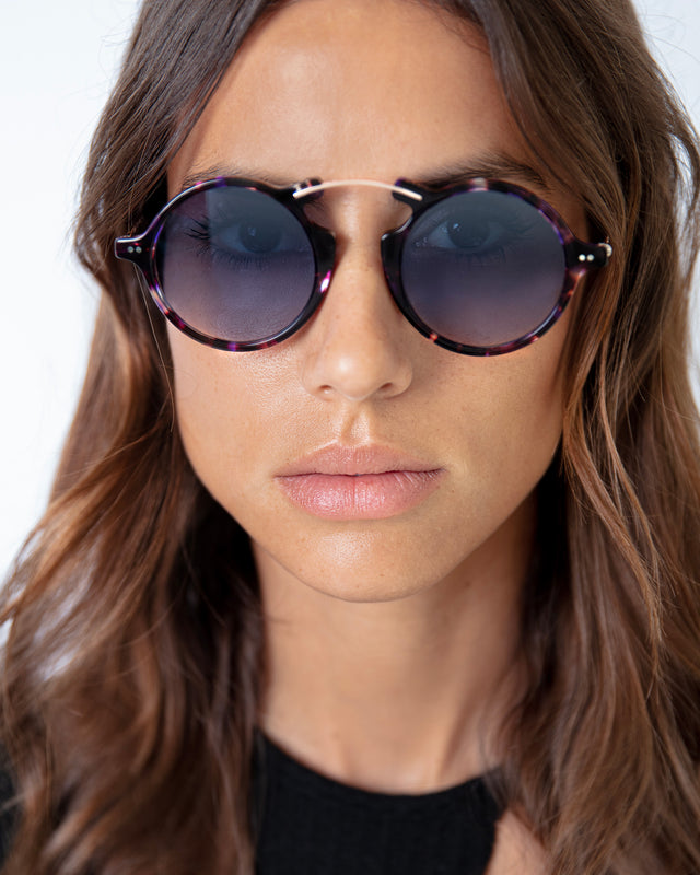 Brunette model with wavy hair wearing Roma II Sunglasses Berry Tortoise with Silver Flat Mirror Gradient