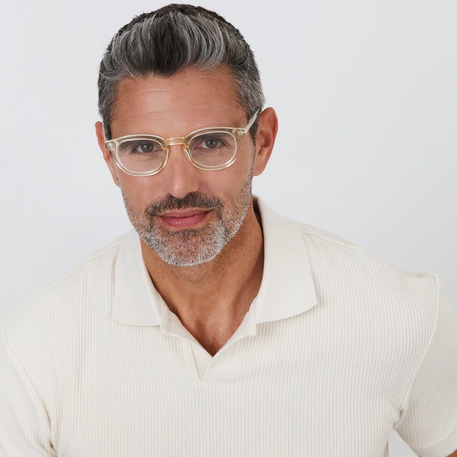 Model with salt and pepper hair and beard wearing Slope Optical Champagne Optical