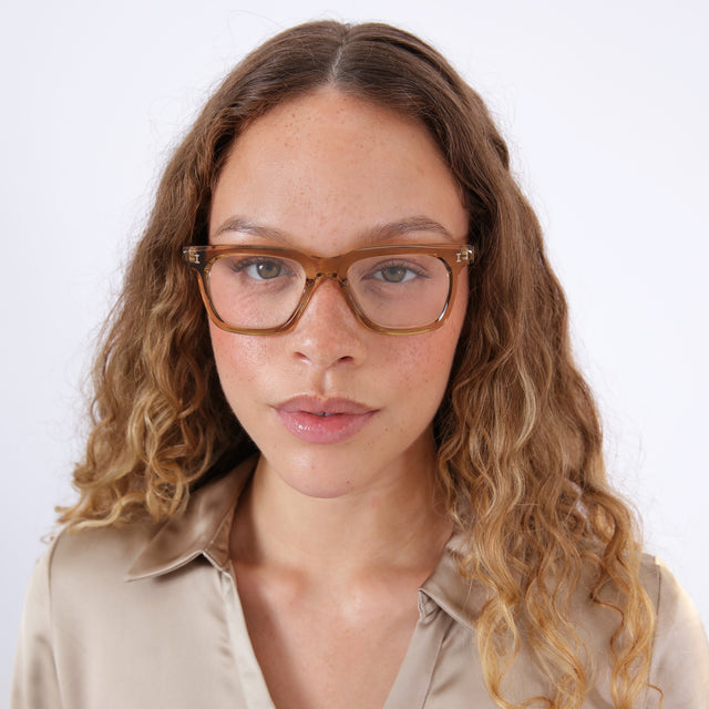 Brunette model with ombré wavy hair wearing Toscana Optical Brown Optical