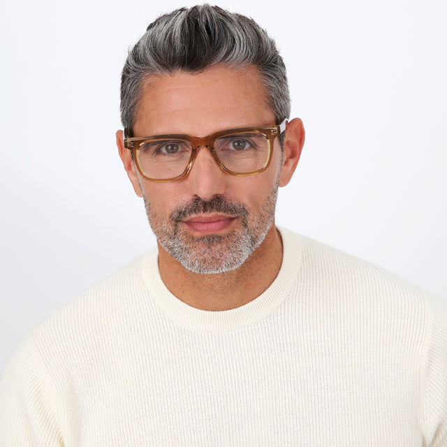 Model with salt and pepper hair and beard wearing Toscana Optical Brown Optical