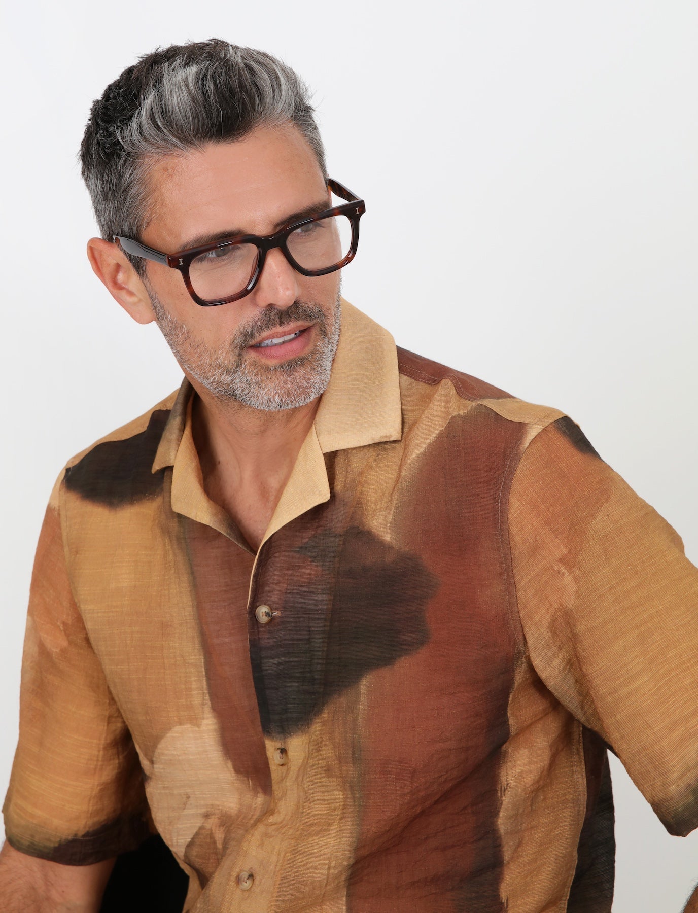 Man in a high fashion brown linen shirt wearing Toscana Optical in Havana.