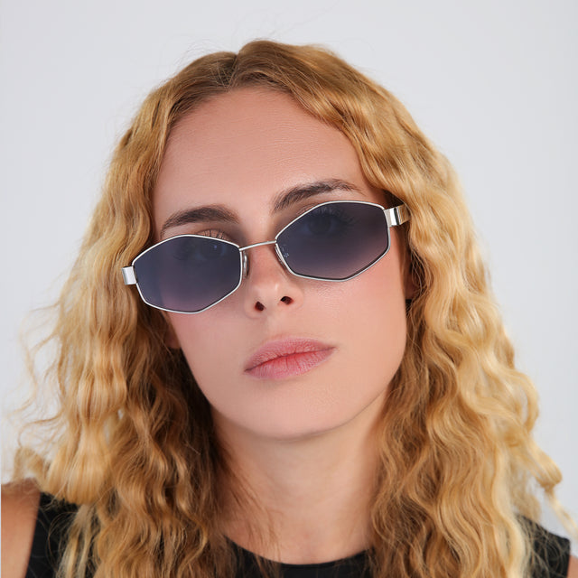 Model with blonde, wavy hair wearing Tucson Sunglasses Gold/Star Tortoise with Midnight Blue Gradient