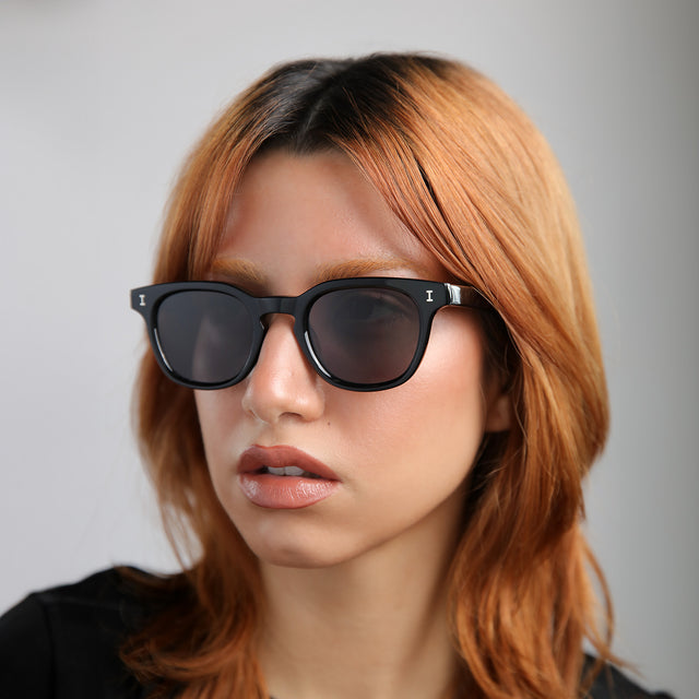 Another angle of model with red hair wearing Veneto Sunglasses Black with Grey Flat