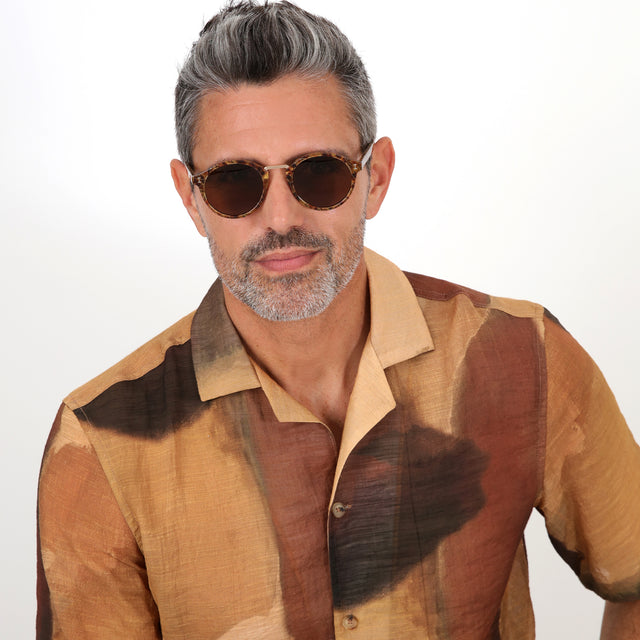Model with salt and pepper hair and beard wearing Village Sunglasses Pecan/Gold with Brown