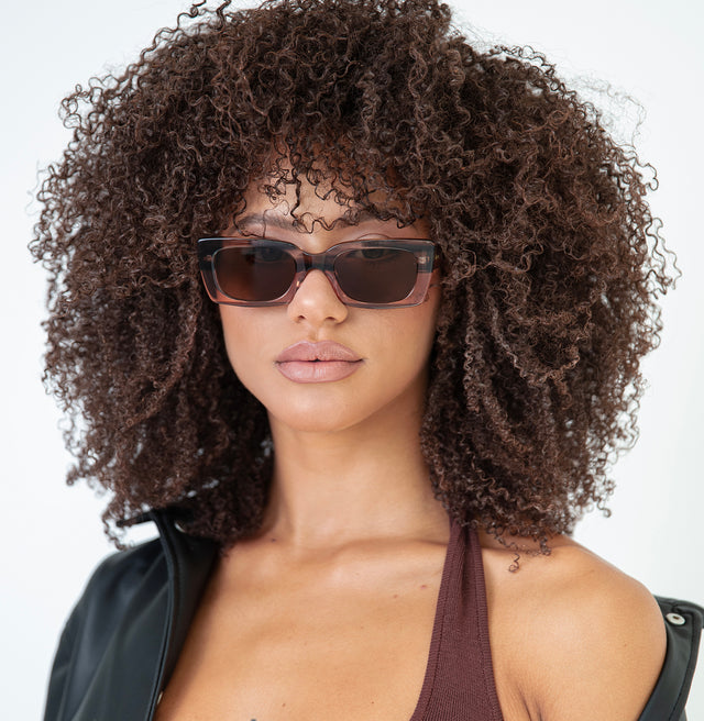 Brunette model with afro-curly hair Wilson Sunglasses Side Profile in Dusty Peach / Brown Flat