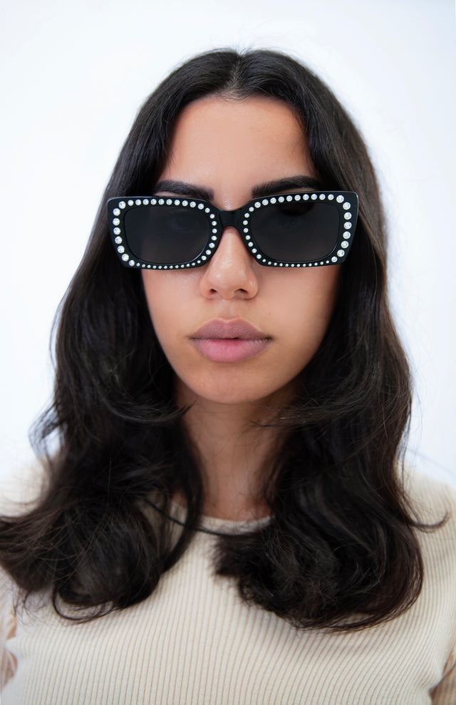 Brunette model with wavy hair wearing Wilson II Crystal Sunglasses Black w/ Silver Swarovski Crystals with Grey Flat