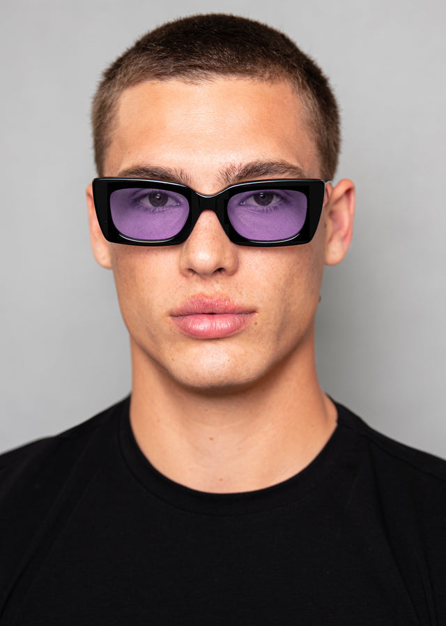 men fit model wearing Wilson II sunglasses in black with purple lenses