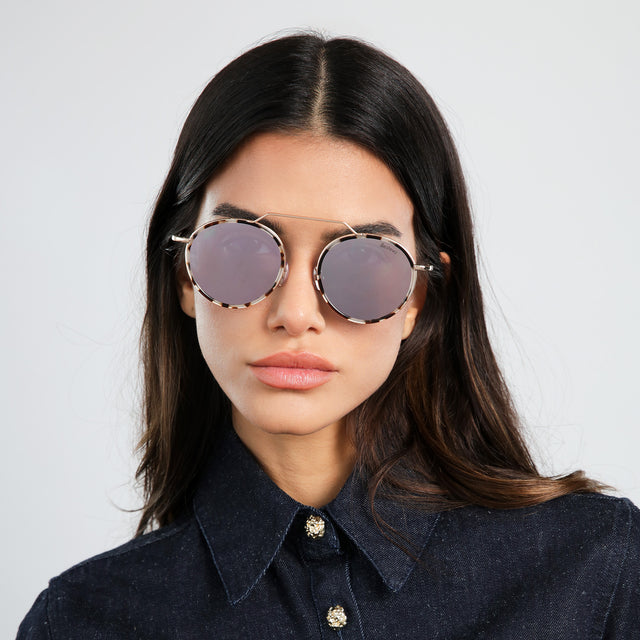 Brunette model in a denim blouse wearing Wynwood Ace Sunglasses White Tortoise/Gold with Bright Rose Flat Mirror