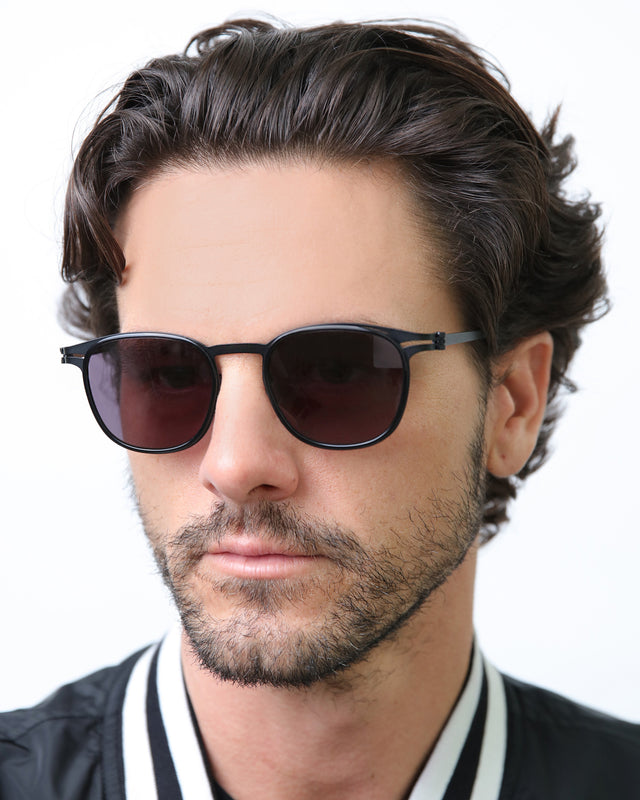 Model with wavy hair wearing Astor Titanium Sunglasses Black/Matte Black with Grey
