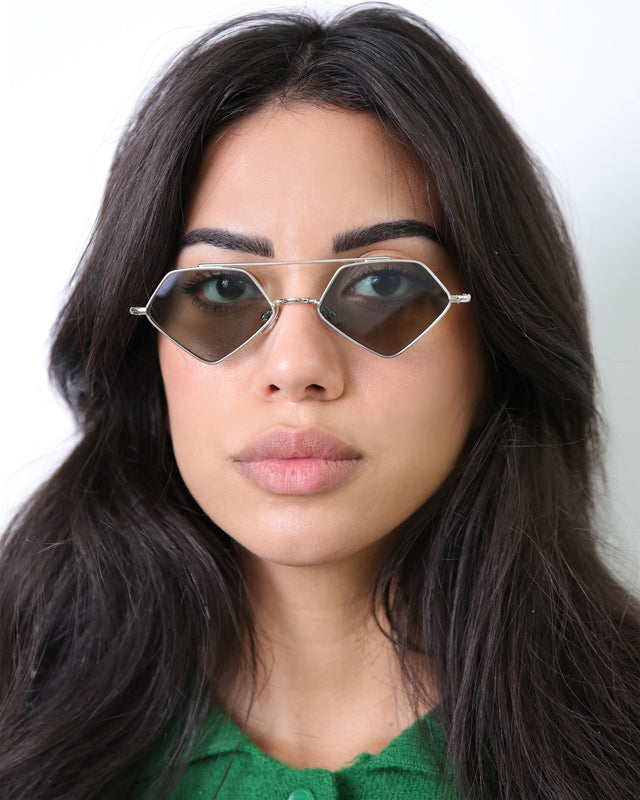 Brunette model with wavy hair wearing Bayley Sunglasses Silver with Olive Flat