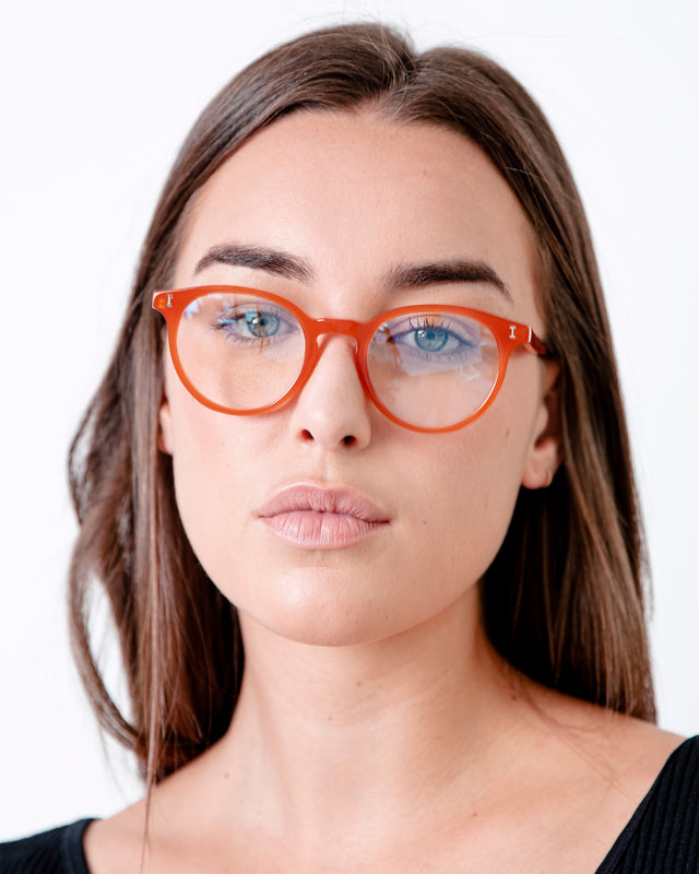 Brunette model wearing Dakota Optical Tangerine Optical