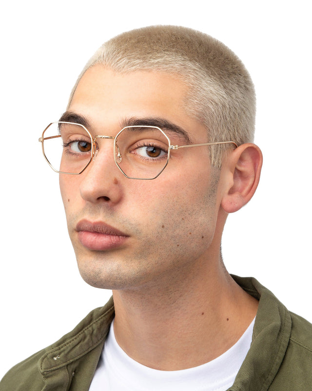 Model with blonde buzzcut wearing Dylan Optical Gold Optical