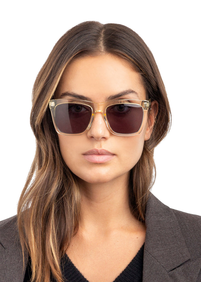 Brunette model with wavy hair wearing Los Feliz Sunglasses Champagne with Grey