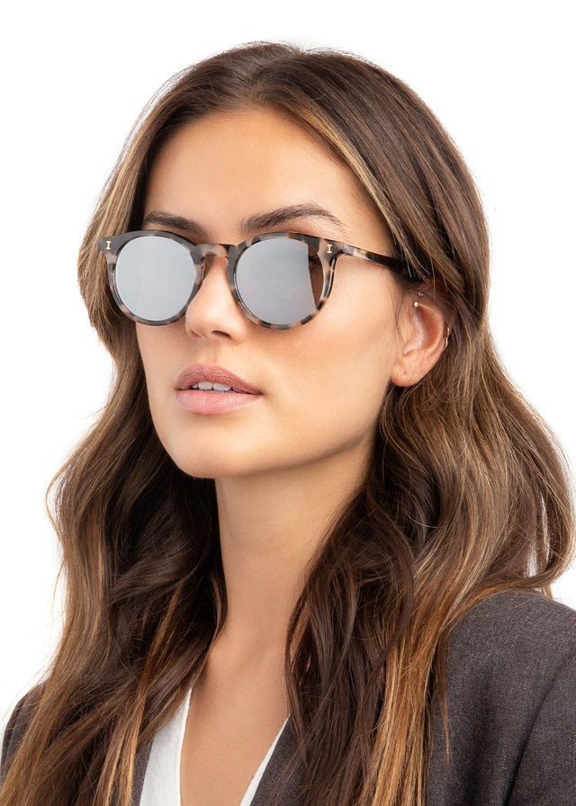 Brunette model with wavy hair wearing Sterling Sunglasses White Tortoise with Silver Flat Mirror