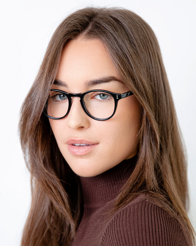 Brunette model with straight hair wearing Lawrence Optical Black Optical