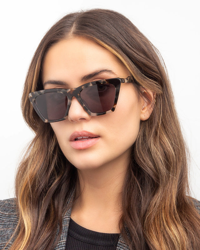 Brunette model with wavy hair wearing Lisbon Sunglasses White Tortoise with Grey