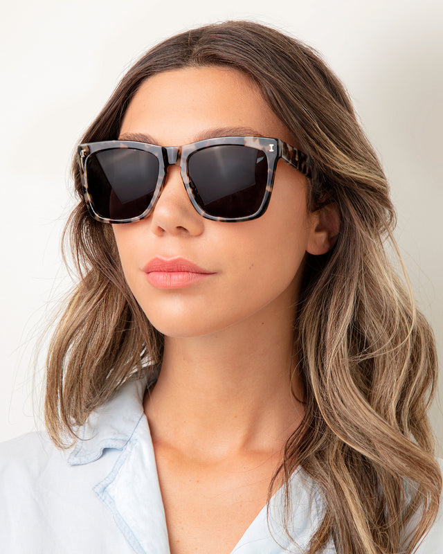 Brunette model with ombre wavy hair wearing Los Feliz Sunglasses White Tortoise with Grey