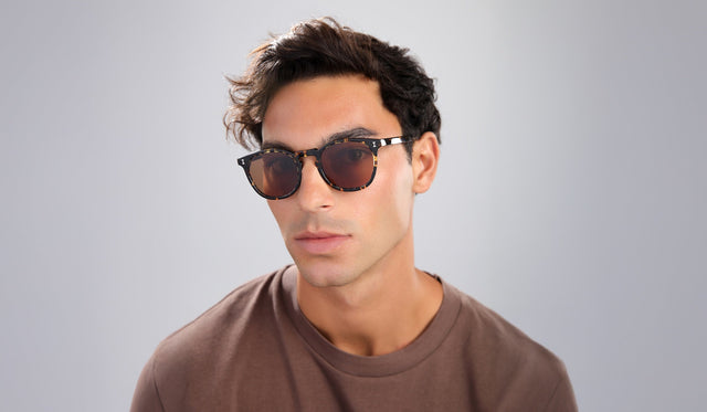 Man in a brown shirt wearing the Eldridge Sunglasses in Flame