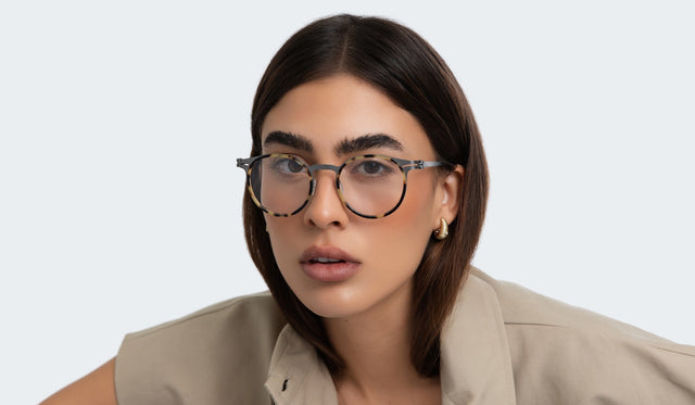 Woman in a trench coat wearing the Great Jones Titanium