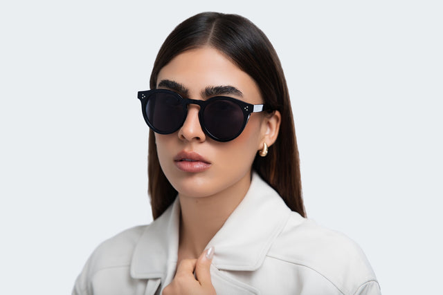 Woman in a trench coat wearing the Leonard II E Sunglasses in Black