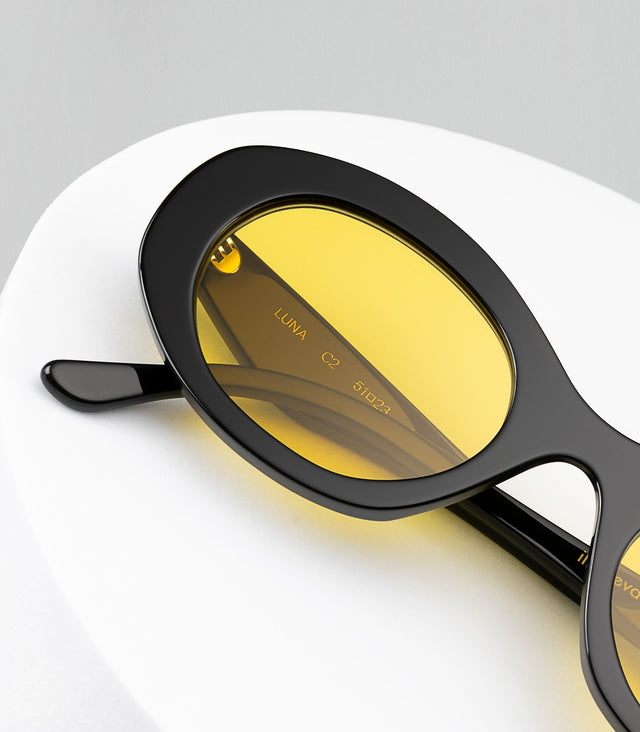 The Luna in Black with Honey See Through lenses displayed on a tray